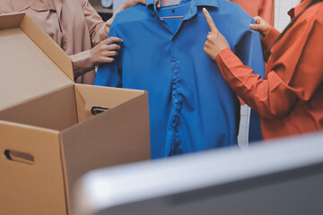 Portrait of Starting small businesses SME owners, two Asian woman check online orders Selling...