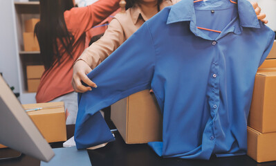 Portrait of Starting small businesses SME owners, two Asian woman check online orders Selling...