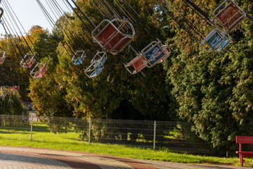 Children's carousels and swings in the amusement park