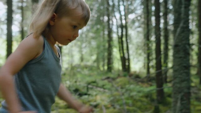 Young free spirit tomboy runs through woods in summer, close profile tracking
