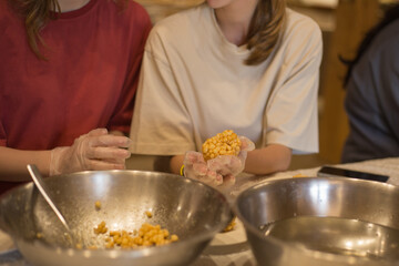 Women's hands forms chak-chak in kitchen. Traditional Tatar food dessert made of dough and honey.