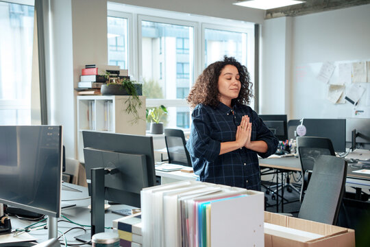 Businesswoman practicing yoga in office