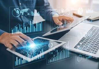 Person interacting with digital charts on a tablet and laptop