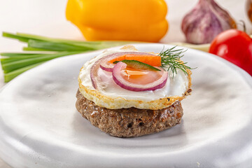 Beefsteak chop with roasted egg