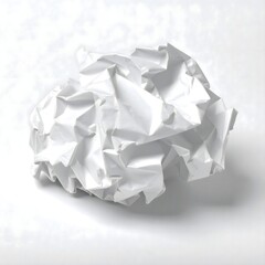 Wrinkled white paper ball on soft surface, representing discarded drafts or a fresh start in creativity.