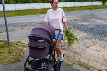 young mother with a stroller doing her daily chores near her private house