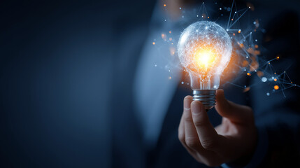 Businessman holding a glowing light bulb with futuristic technology concept