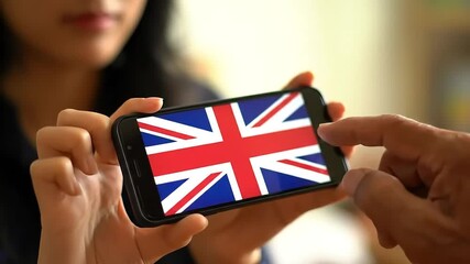 UK flag on phone, indoor view, woman, hand - Powered by Adobe