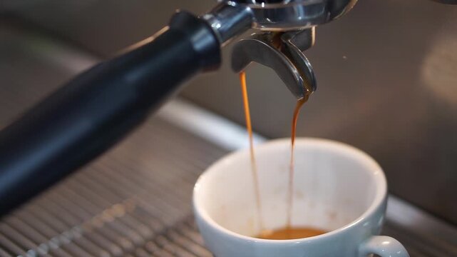 Close up making coffee with traditional coffee maker machine and sound on.
