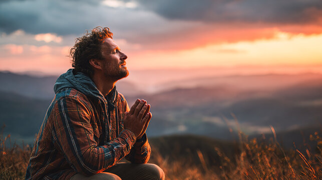 Man finds peace in nature, praying at sunset over mountains, seeking hope and gratitude with stunning scenic backdrop for wellness retreats
