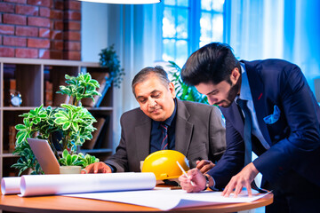 Indian architects collaborate on creative blueprints and interior layouts in stylish office setting