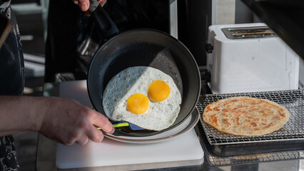 The chef fries the eggs sunny side up. 