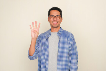 Adult Asian man smiling happy while give four fingers sign