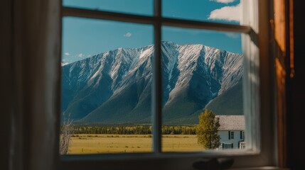 Fototapeta premium Snowy mountains viewed through a window.