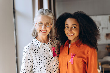 Women wearing pink ribbon showing support for breast cancer awareness