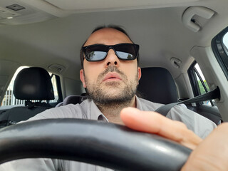 Uomo alla guida dell'automobile per le strade della città