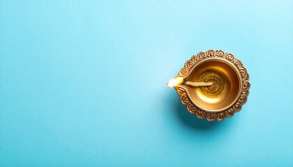Top view of diwali diya lamp on blue background.