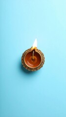 Top view of diwali diya oil lamp on blue background