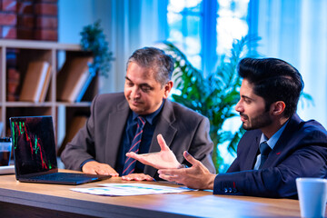 Young Indian executives talk stock market trends and profits during investment planning session