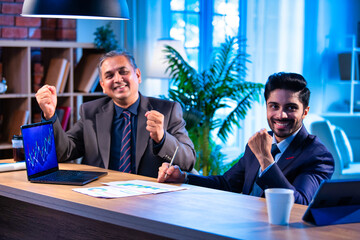 Young Indian executives talk stock market trends and profits during investment planning session