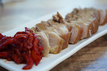 Korean Boiled Pork with Spicy Pollack Salad on White Plate