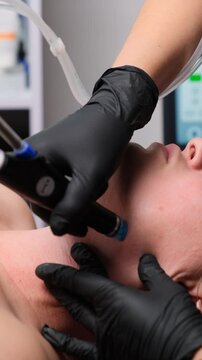 Aesthetic facial procedure performed by a beautician using modern device for skin tightening and anti-aging.