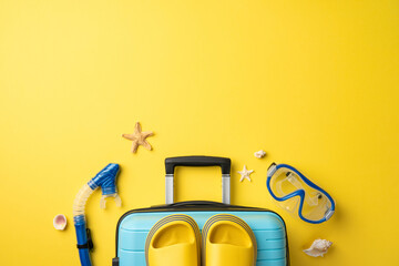 Blue suitcase with yellow sandals and snorkeling gear against a vibrant yellow backdrop
