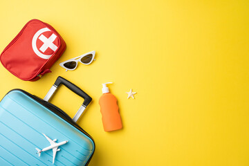 Flat lay featuring a suitcase, sunglasses, first aid kit, sunscreen, on a bright backdrop