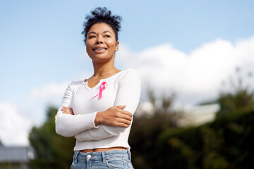 Young woman smiling and supporting breast cancer awareness