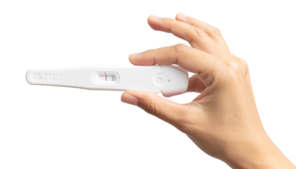 positive pregnancy on test strip holded in hand pregnancy test strip, awareness concept 