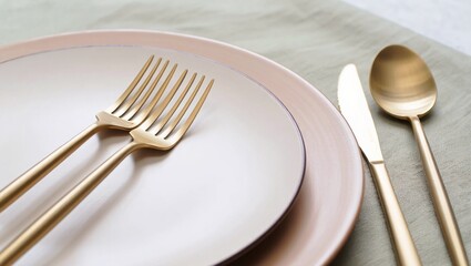Elegant Golden Cutlery on Ceramic Plate a Stylish Table Setting for Fine Dining and Special Occasions