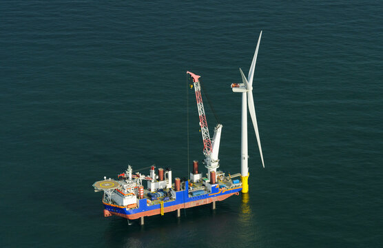 Construction crane vessel constructing wind turbine in sea