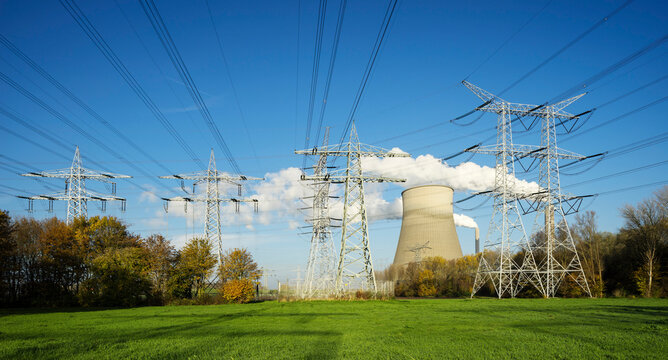 Electricity pylon and steaming cooling towers in Netherlands