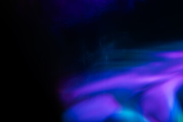 Abstract blurred colorful lens flare bokeh on black,