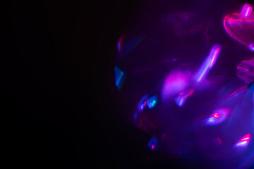 Blurred Light painting one exposure in camera. light glares with a spectral gradient on a dark background.