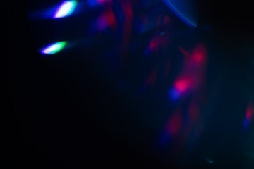 Colorful light leak on black background, abstract design with optical lens flare shot on a long lens