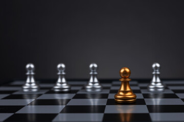 A golden pawn stands in the middle of a row of white pawns,
