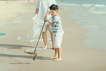 On the beach, a father and son carry bags to collect trash. Clean up the dirty sea or ocean and...
