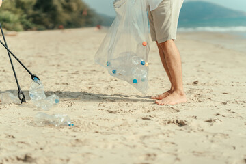 Family carry a bag to collect trash on the beach and clean up the dirty sea while collecting...