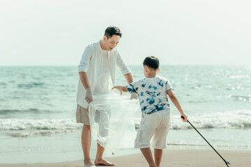 On the beach, a father and son carry bags to collect trash. Clean up the dirty sea or ocean and...