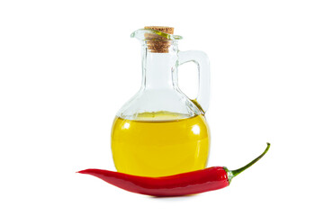 Olive oil in a transparent jug and red chili pepper.