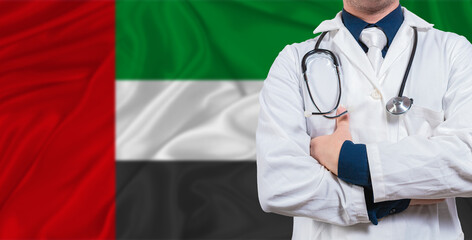 Male doctor with stethoscope on United Arab Emirates flag. Doctor holding stethoscope on United Arab Emirates flag