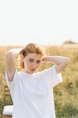 Young Redhead Woman in White T-Shirt Outdoors in Summer Light