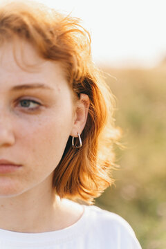 Close-Up of Woman with Red Hair Wearing Silver Earring