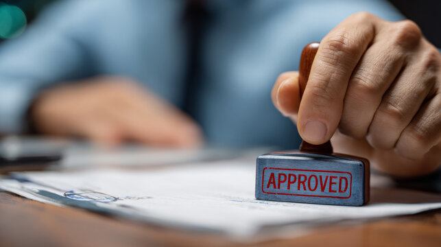 Close up of professional man hand stamping an approved document for business success