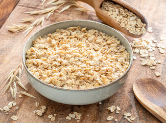 Bowl of porridge or oatmeal on wooden table.