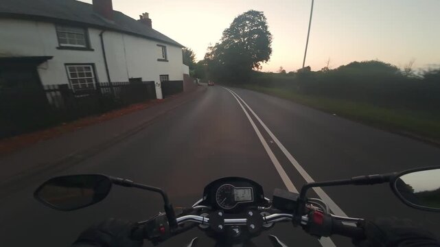 Motorbike driving at the beach at sunset