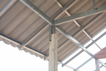 Steel roof frame connected to concrete house pillars