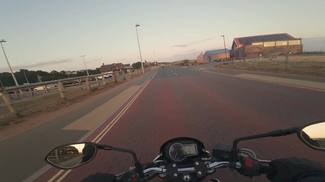 Motorbike driving at the beach at sunset