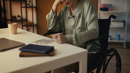 Upset senior woman in wheelchair calculating her budget, struggling with pension - Powered by Adobe